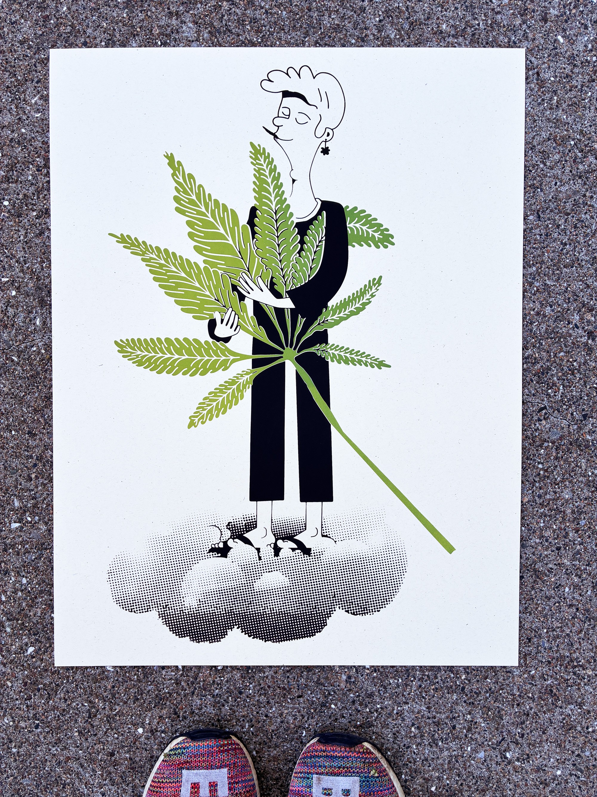 The finished Cannabis Hug screenprint on concrete, with the cannabis man on a cloud hugging a giant leaf
